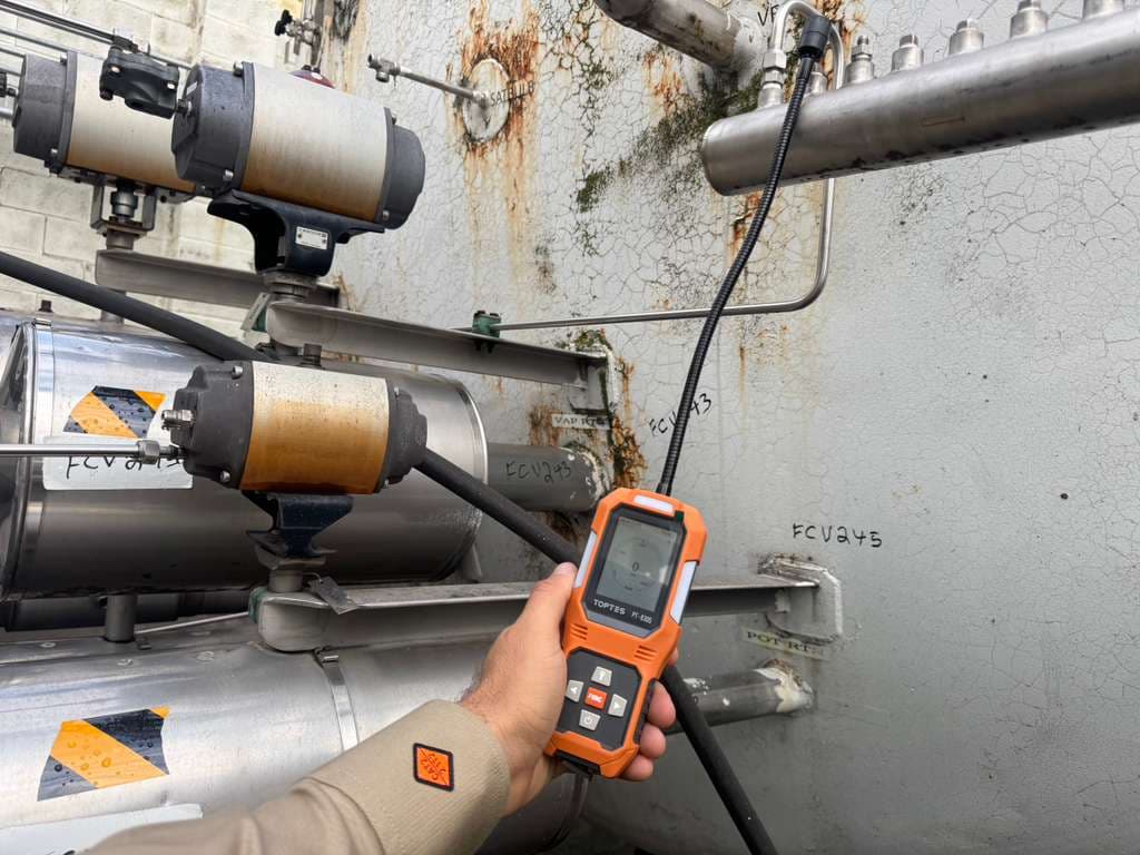 Technician conducting O₂ and gas detection sweep on cryogenic vessel